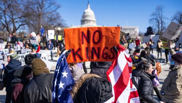 What is the reason for Americans rallying against Trump with the slogan "We don't want a king"?